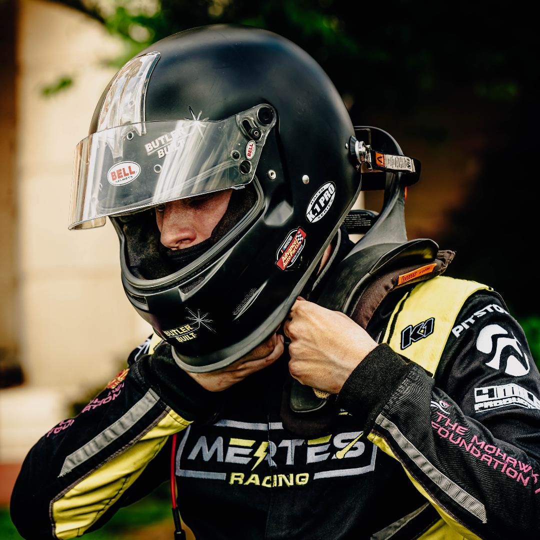 Zachary pulling on his racing helmet